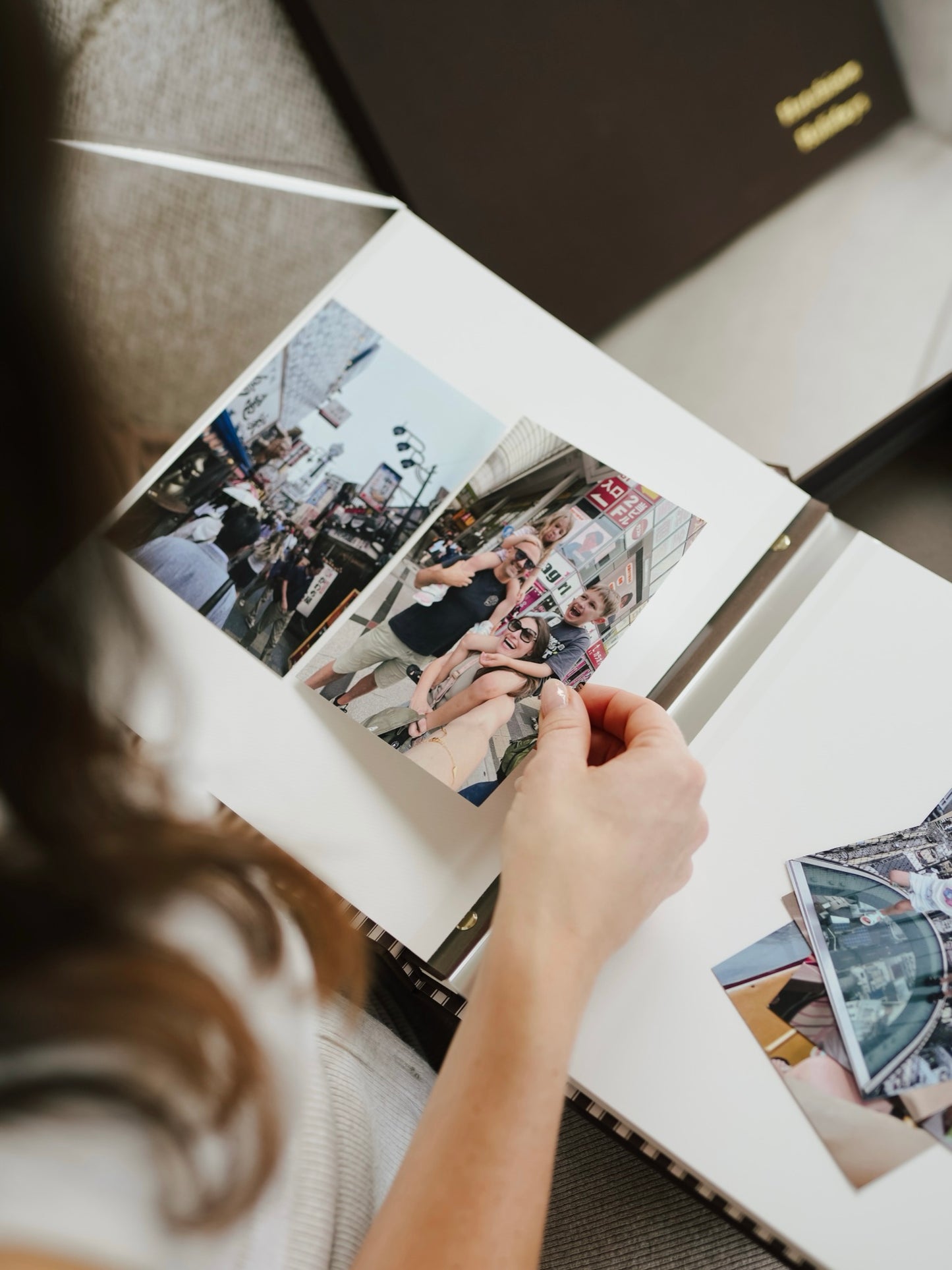Arranging travel photographs in the bespoke keepsake album