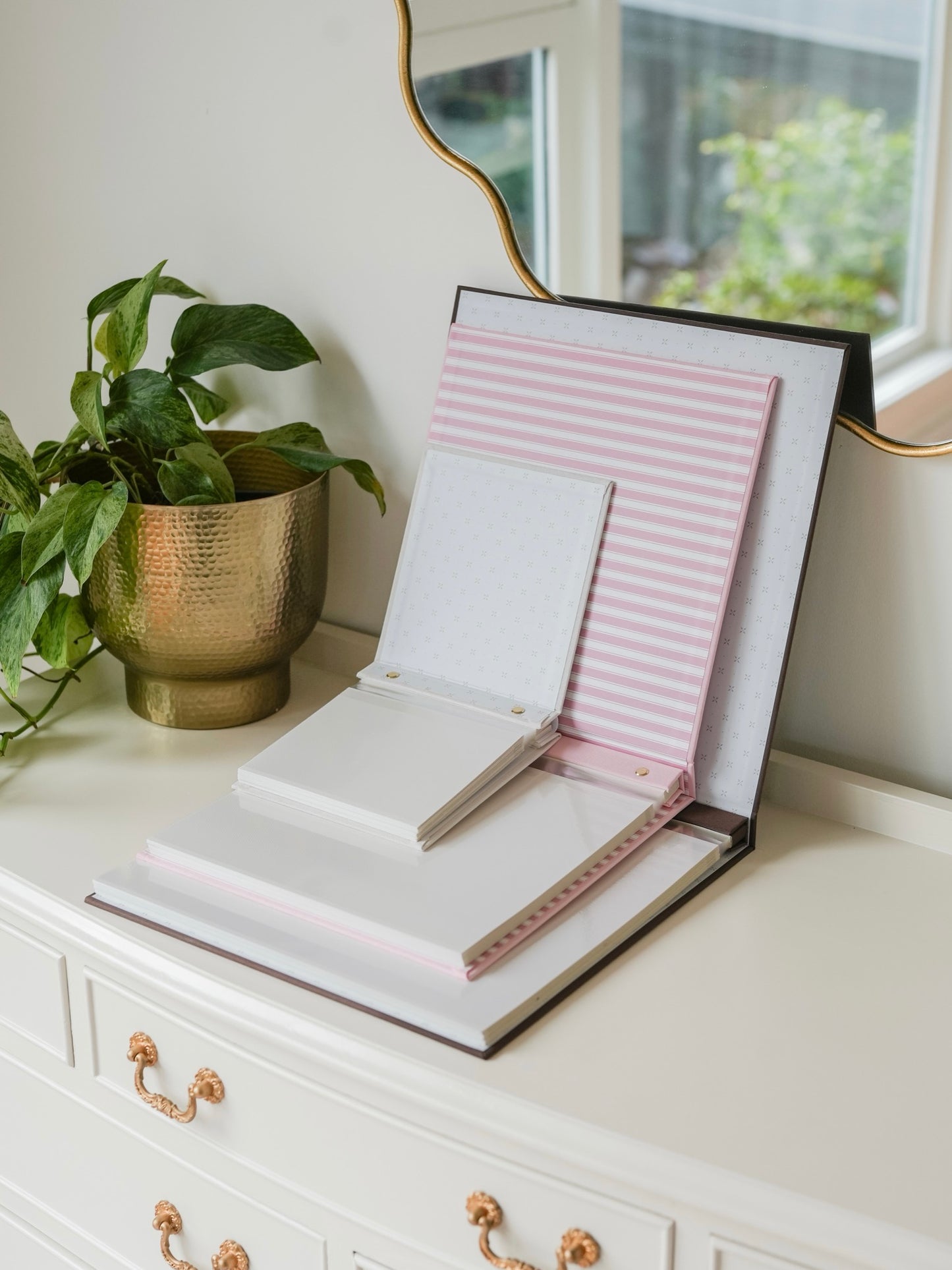 Bespoke photo album shown in three sizes